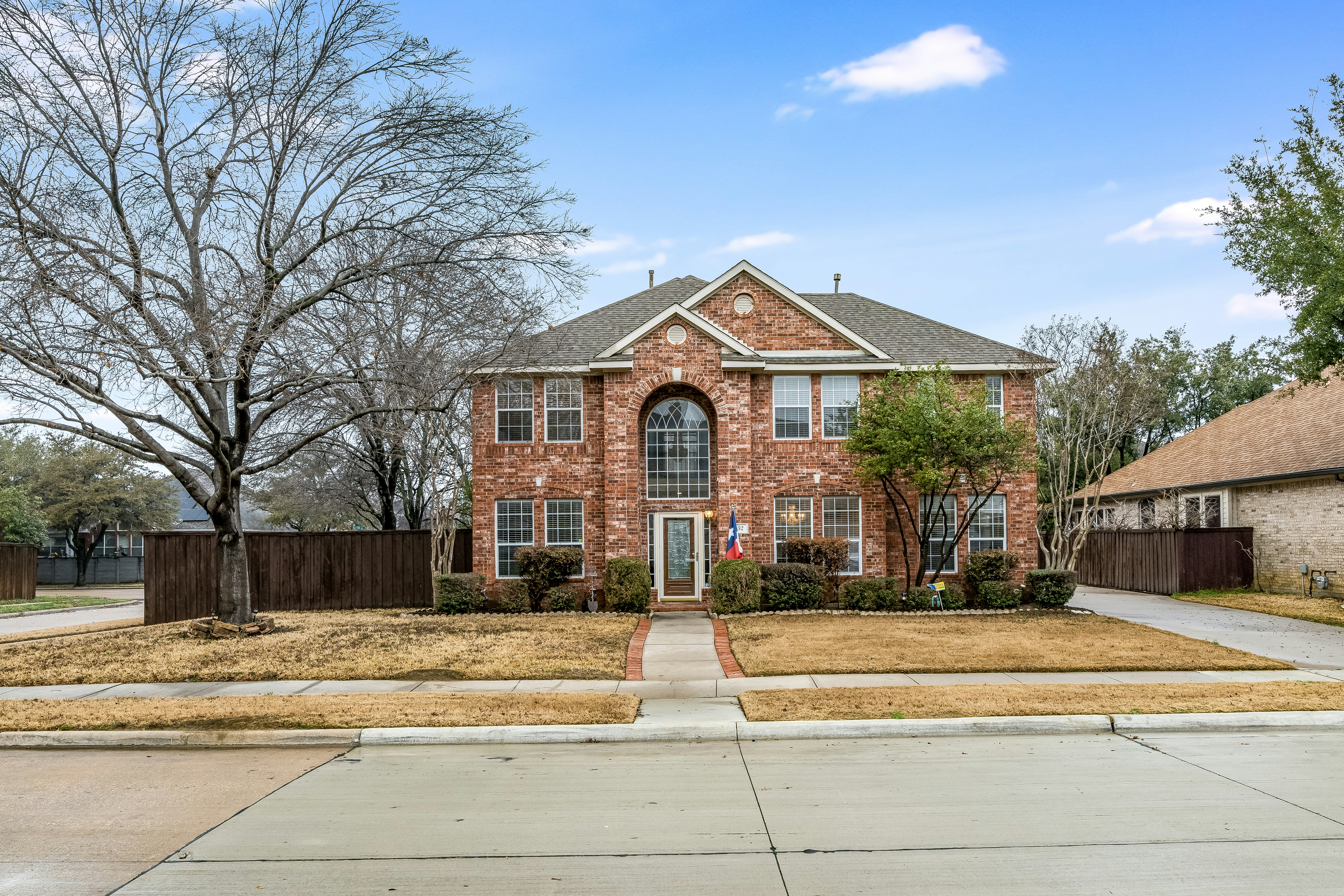 Two-story brick suburban home — the kind a $60,000 salary can realistically afford
